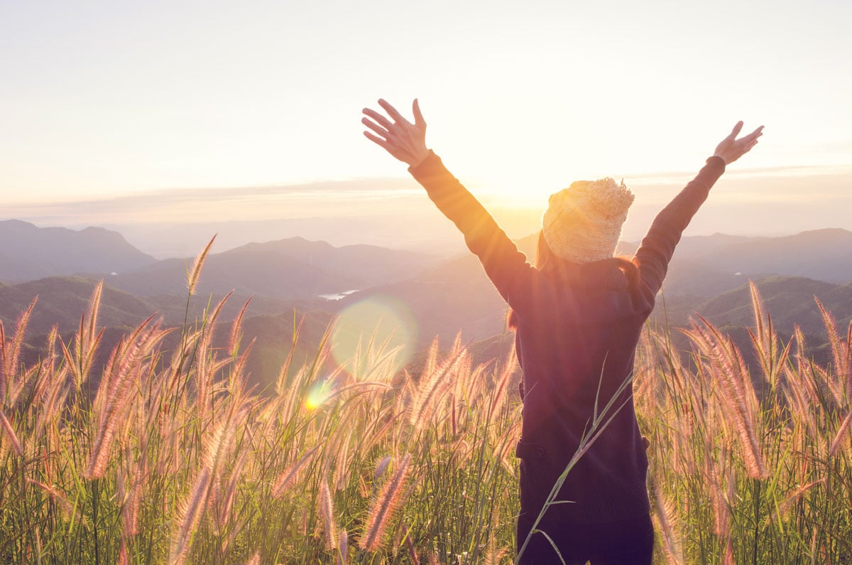 happy girl in field - Healthy Wellbeing - Work Life Balance