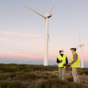 green jobs two men standing in front of wind turbines